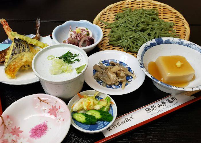 A multi-plate shojin ryori meal at Yudonosan Sanrojo in the Yamagata Prefecture, featuring tofu, tempura, soba and more.